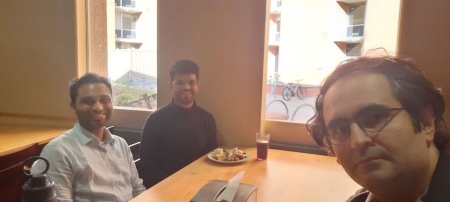 A small group from the High Energy Physics research group enjoying a meal at a restaurant.