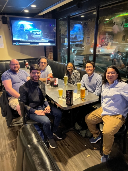 A small group from the High Energy Physics research group enjoying a meal at a restaurant.