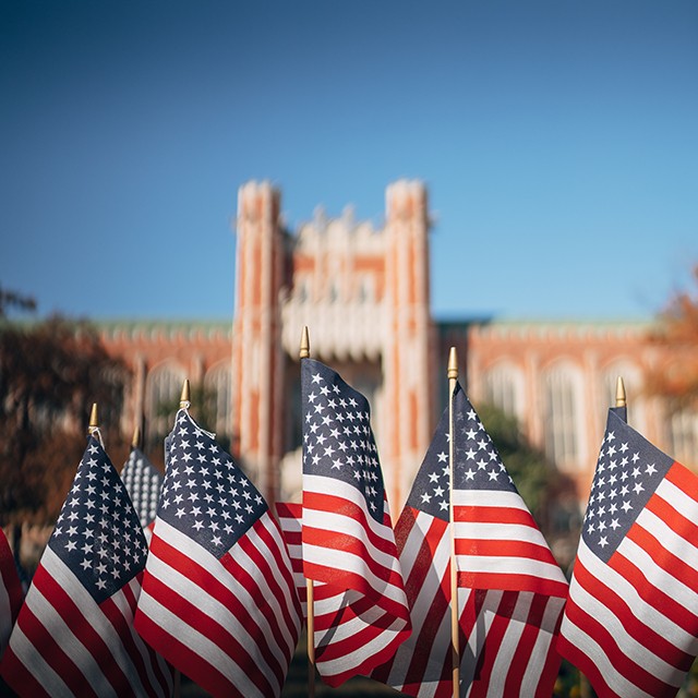Flags in foreground in front of the Bizzell Memorial Library.