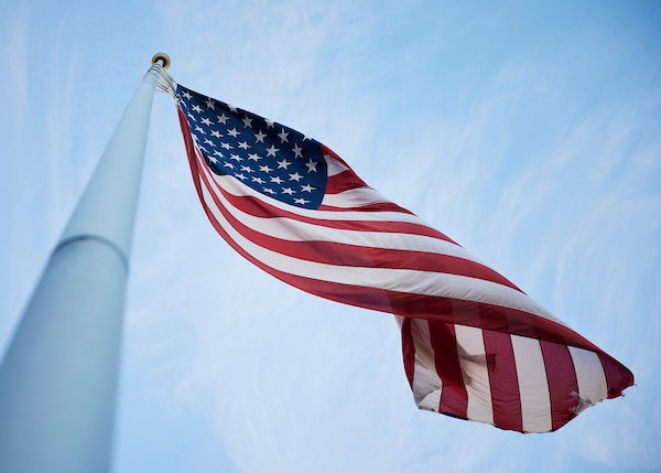 US flag on flagpole waving.