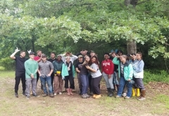 group of students standing in front of trees