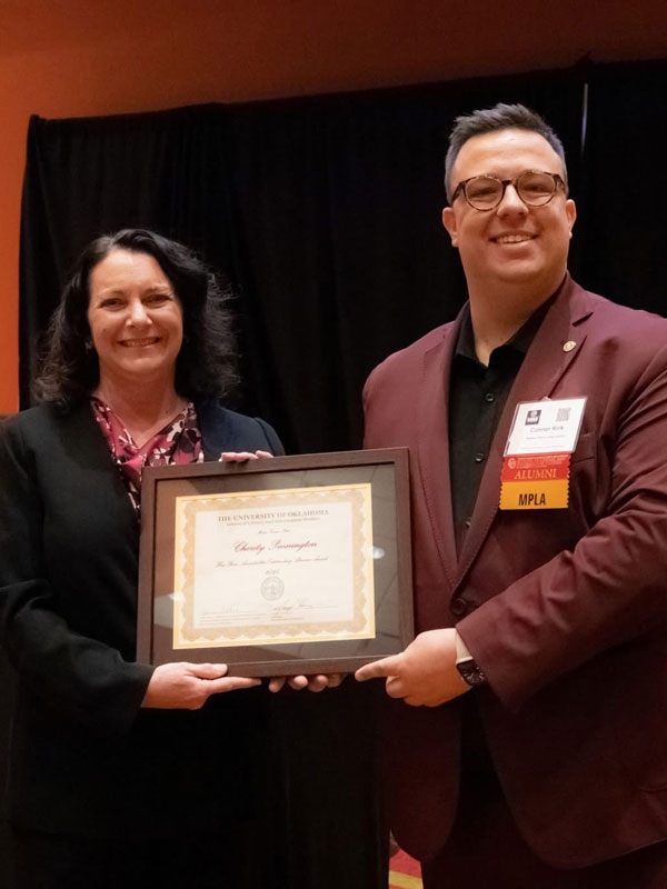 Cherity Pennington award winner with Connor Kirk, SLIS Alumni President.