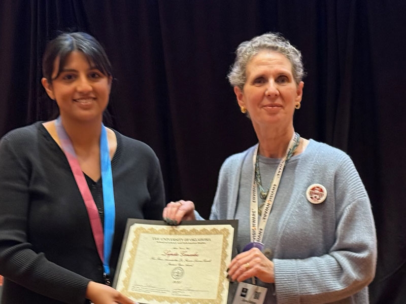 Lupita Gonzalez with Dr. June Abbas receiving the 2025 Student Paper Award.