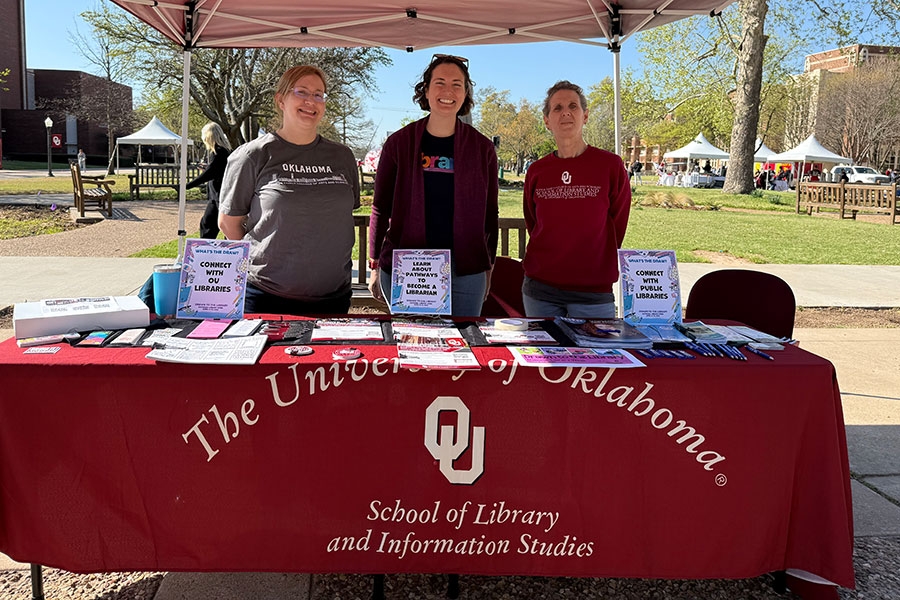 Students crossing the OU campus oval on a sunny day.
