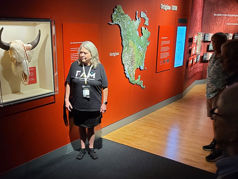 Deji highlights the replica of the Cooper bison skull, the first known example of Indigenous artwork in North America dating to 15,000 years ago. Found near Woodward, OK, at a massive bison hunting site, the original is in the Sam Noble Museum. 
