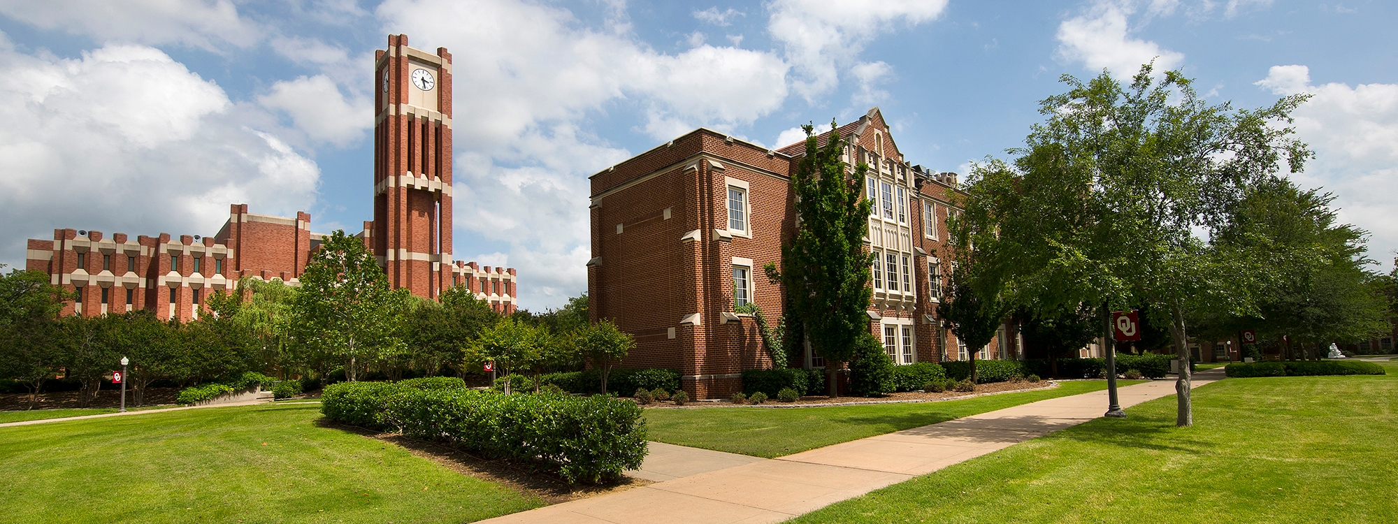 Bizzell Library and clock tower in front of a cloudy sky.