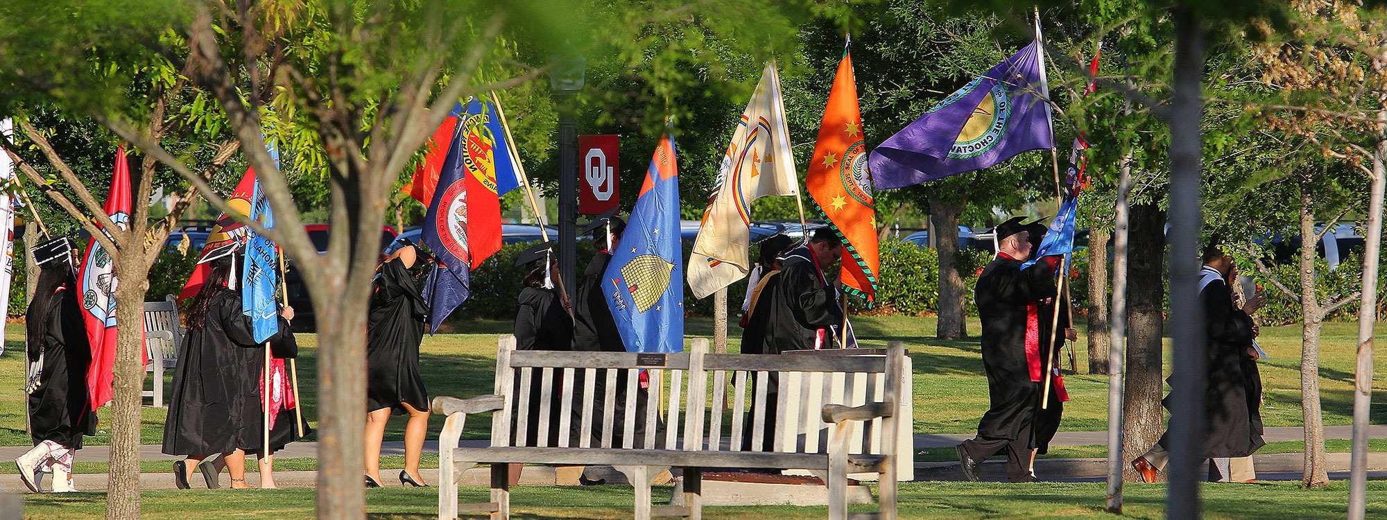 Graduation procession with various commencement flags
