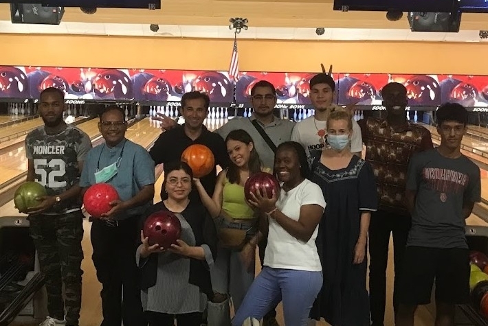 CESL students showing balls in their hands in the bowling center