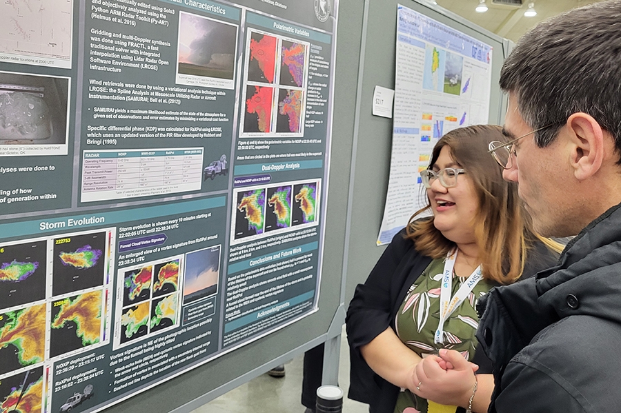 Leah Swinney in front of a research poster.