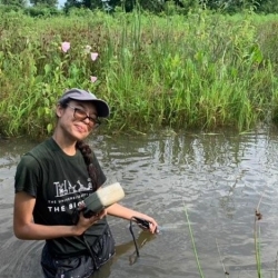 Olivia Mitchell standing in a creek