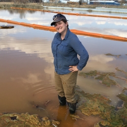 Justine McCann stands in SEC ox-pond waters