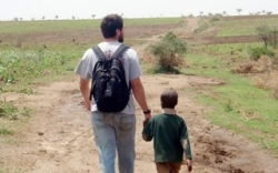 Water Center Student walks with boy in Uganda,OLYMPUS DIGITAL CAMERA