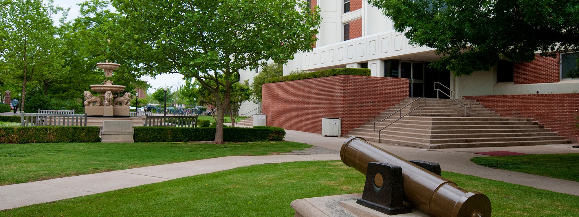 Exterior of the Carson engineering building with fountain and sculpture in the foreground.