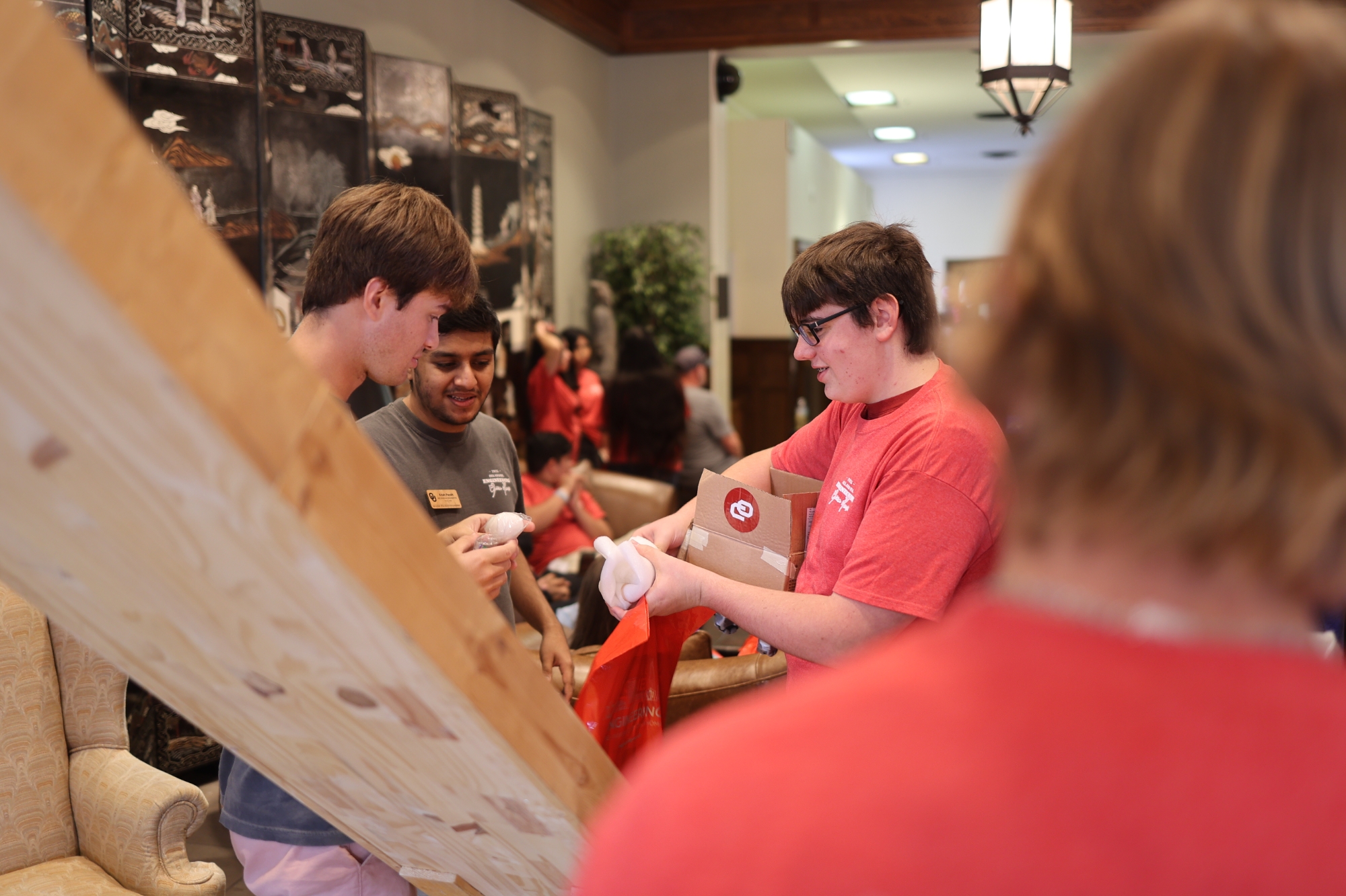 Student looking at their egg after egg drop competition