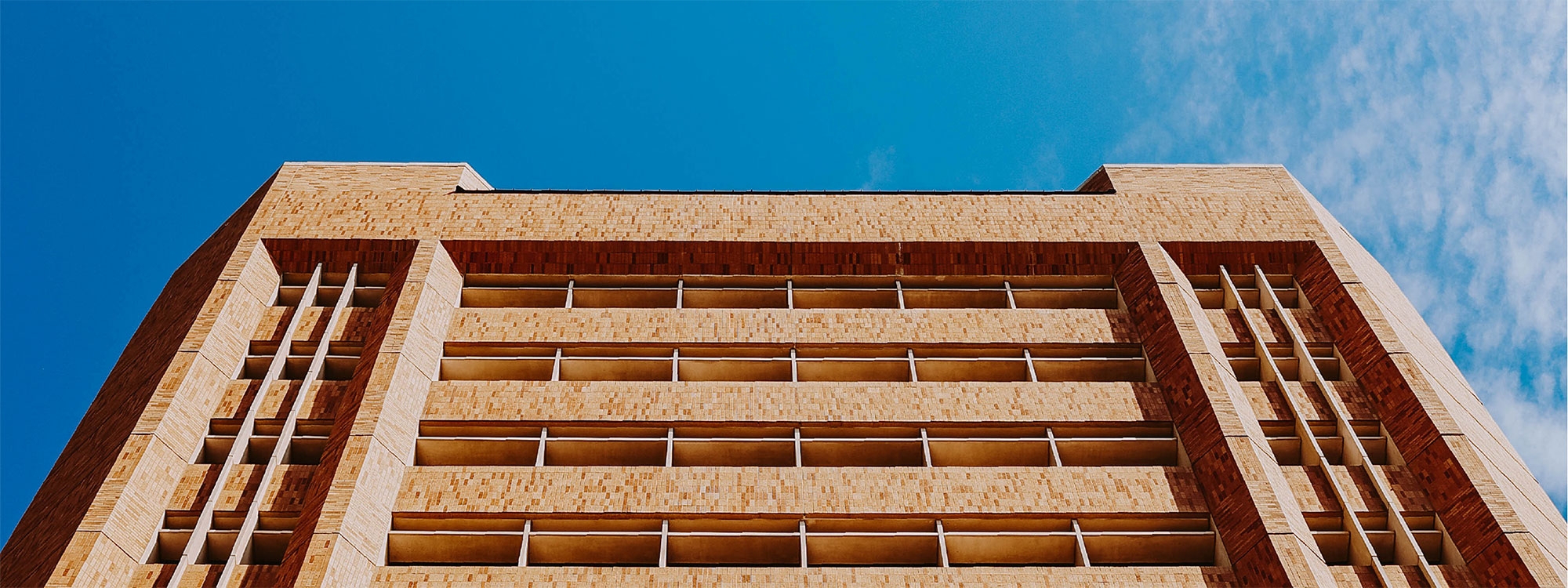 An upward-looking view of the exterior of Sarkeys Energy Center.