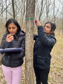 Nitu Adhikari (left) and Nethmi Wickrama Gunarathne (right) taking GPS coordinates and tagging trees.