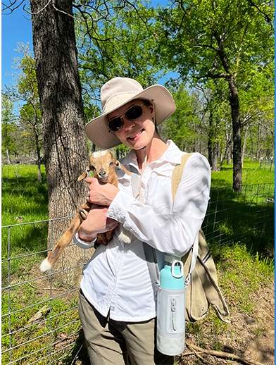 Lori Han holding baby goat.