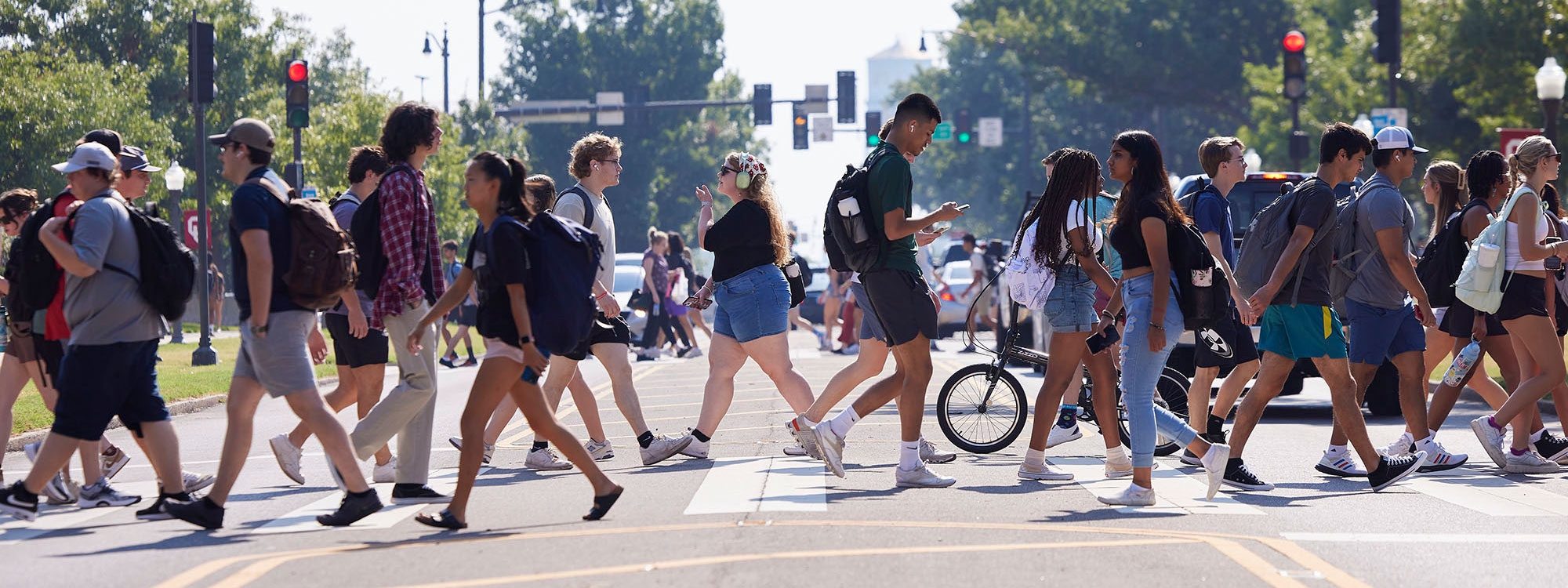 Students crossing the street via a crosswalk.