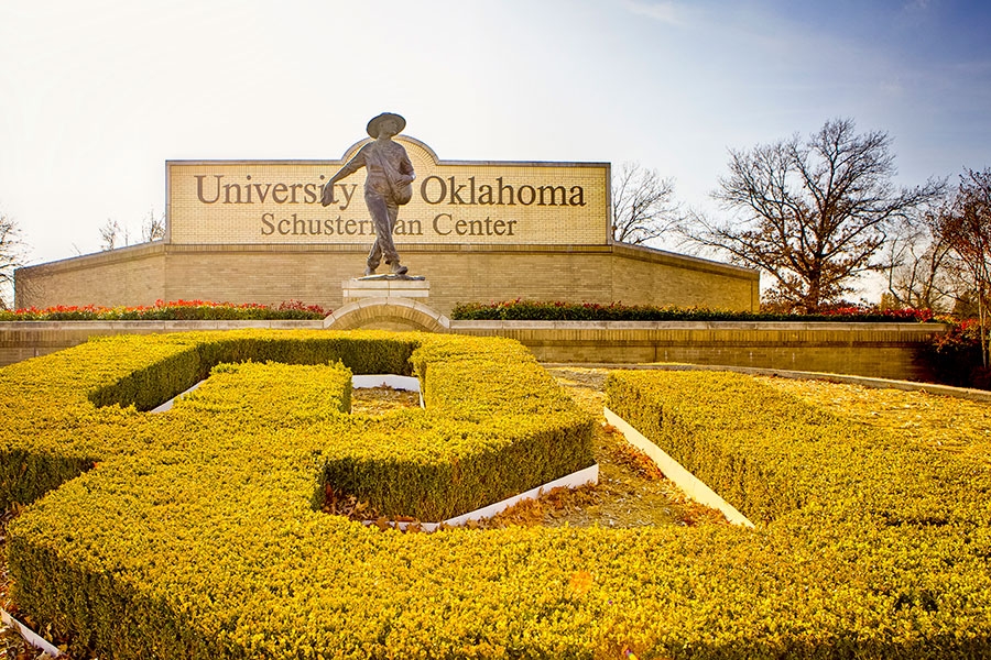 OU topiary and statue near the Schusterman Center sign.