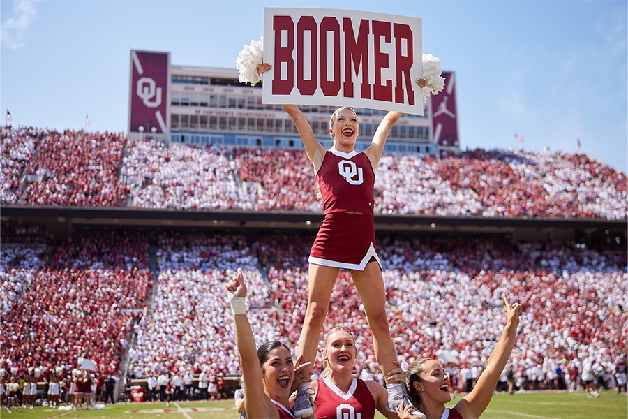 O U cheerleader holding "Boomer" sign.