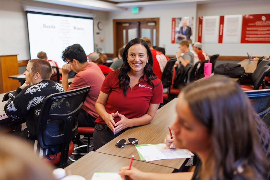 Professor speaking with small group of students.