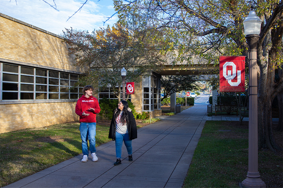 Two students walking on OU-Tulsa's campus.