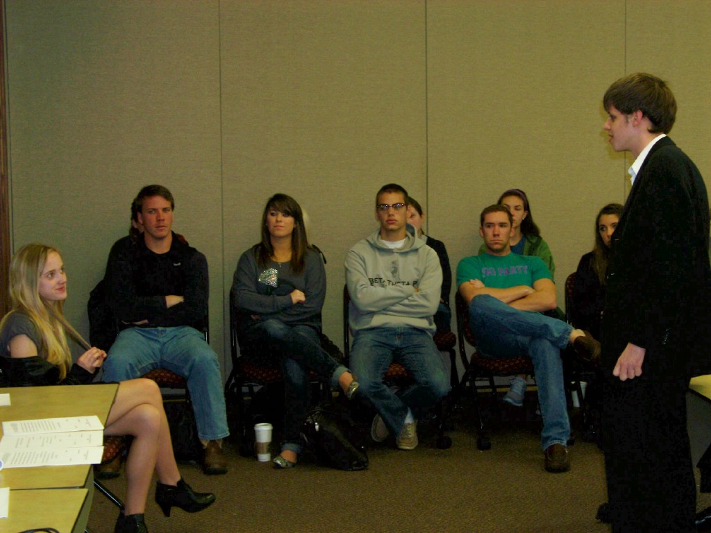 Students listening to a teacher lecture. 