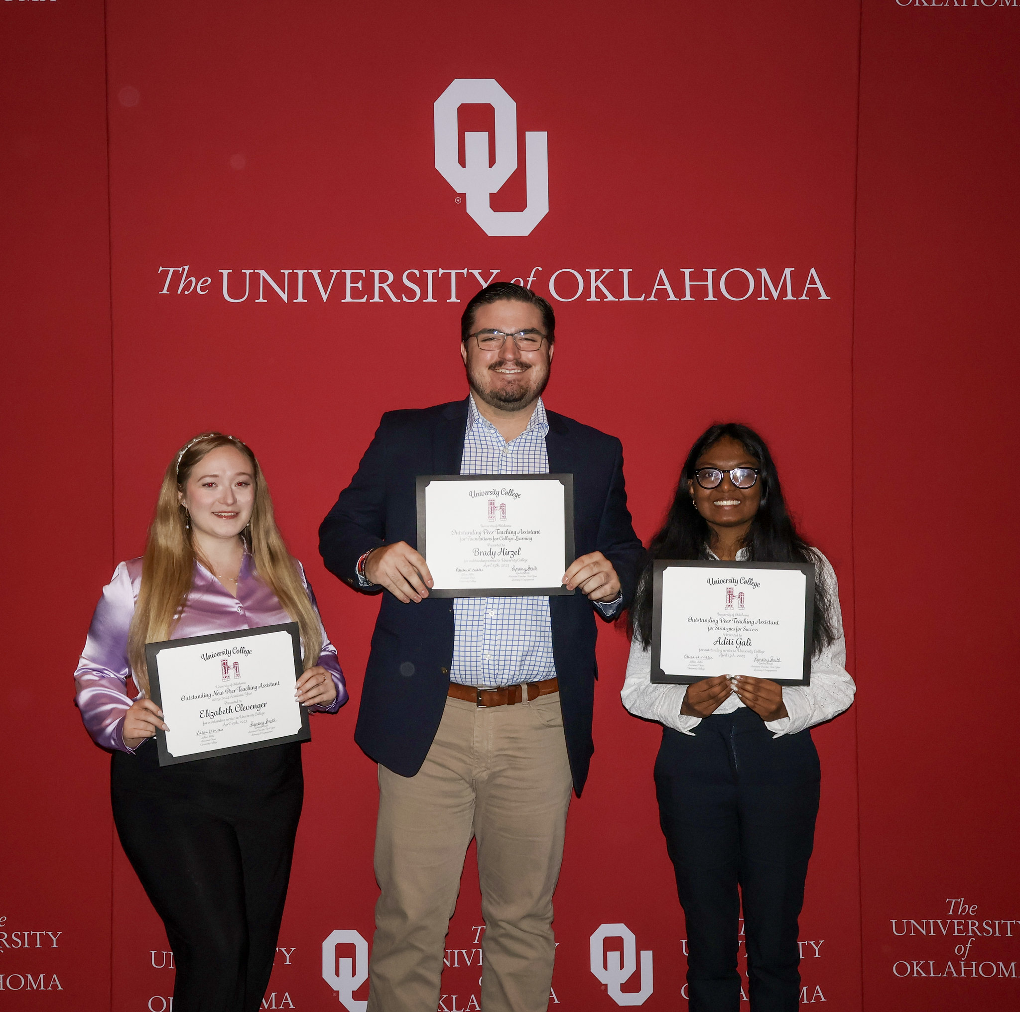 Three PTAs holding up their awards at  a ceremony. 