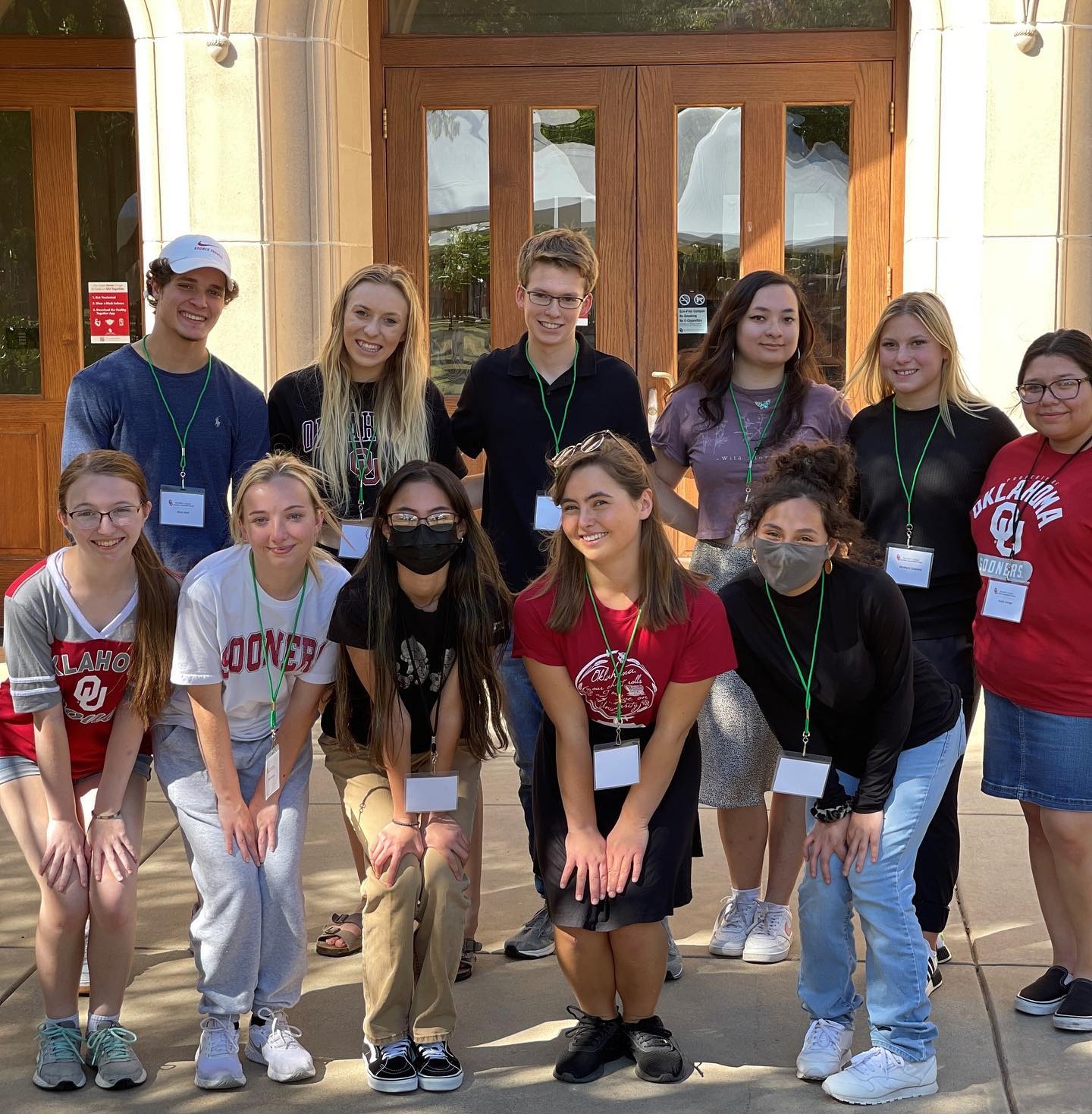 A group of students posing in front of a building.