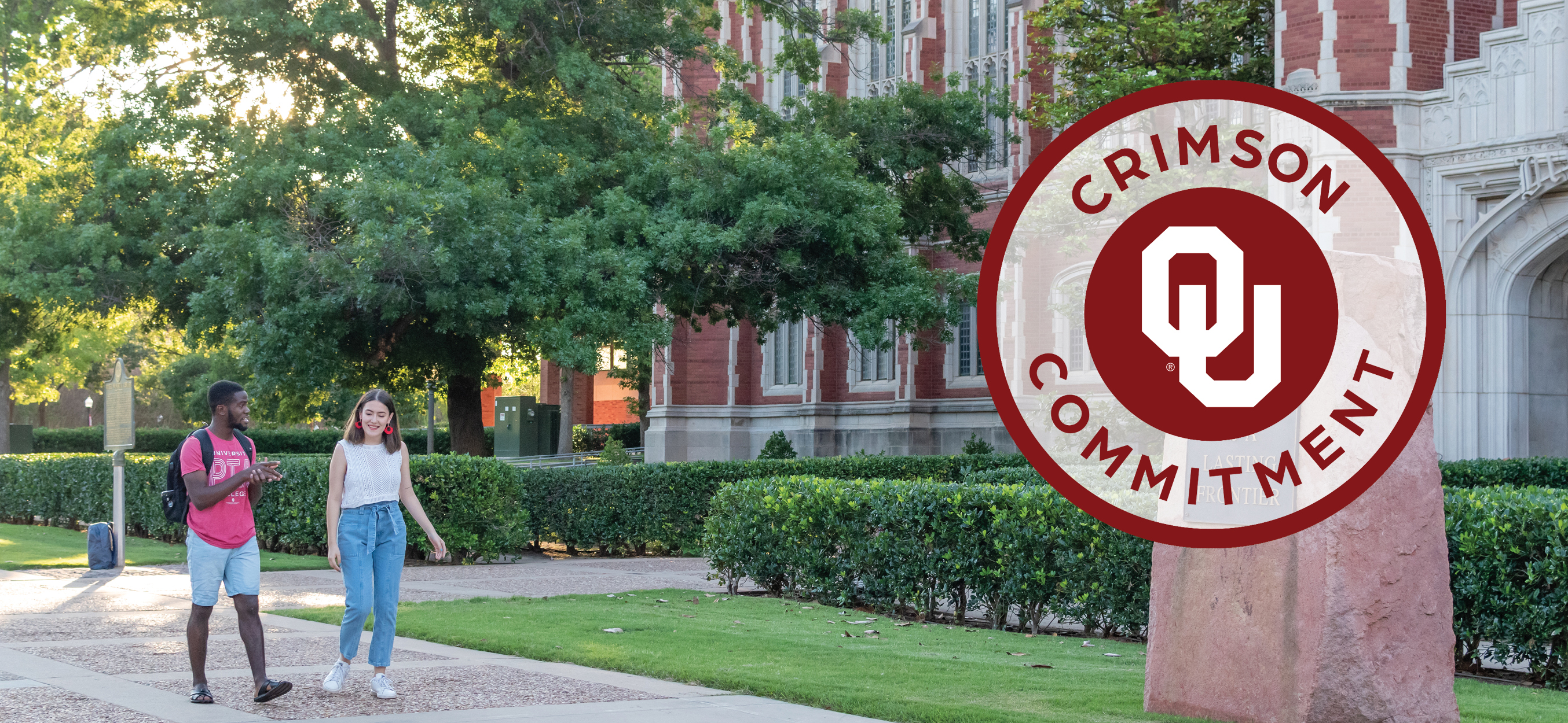 Crimson Commitment: Two students walking on OU campus