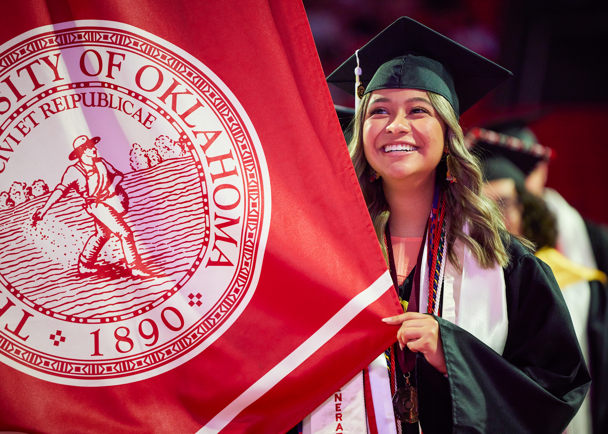 A student holding the OU flag