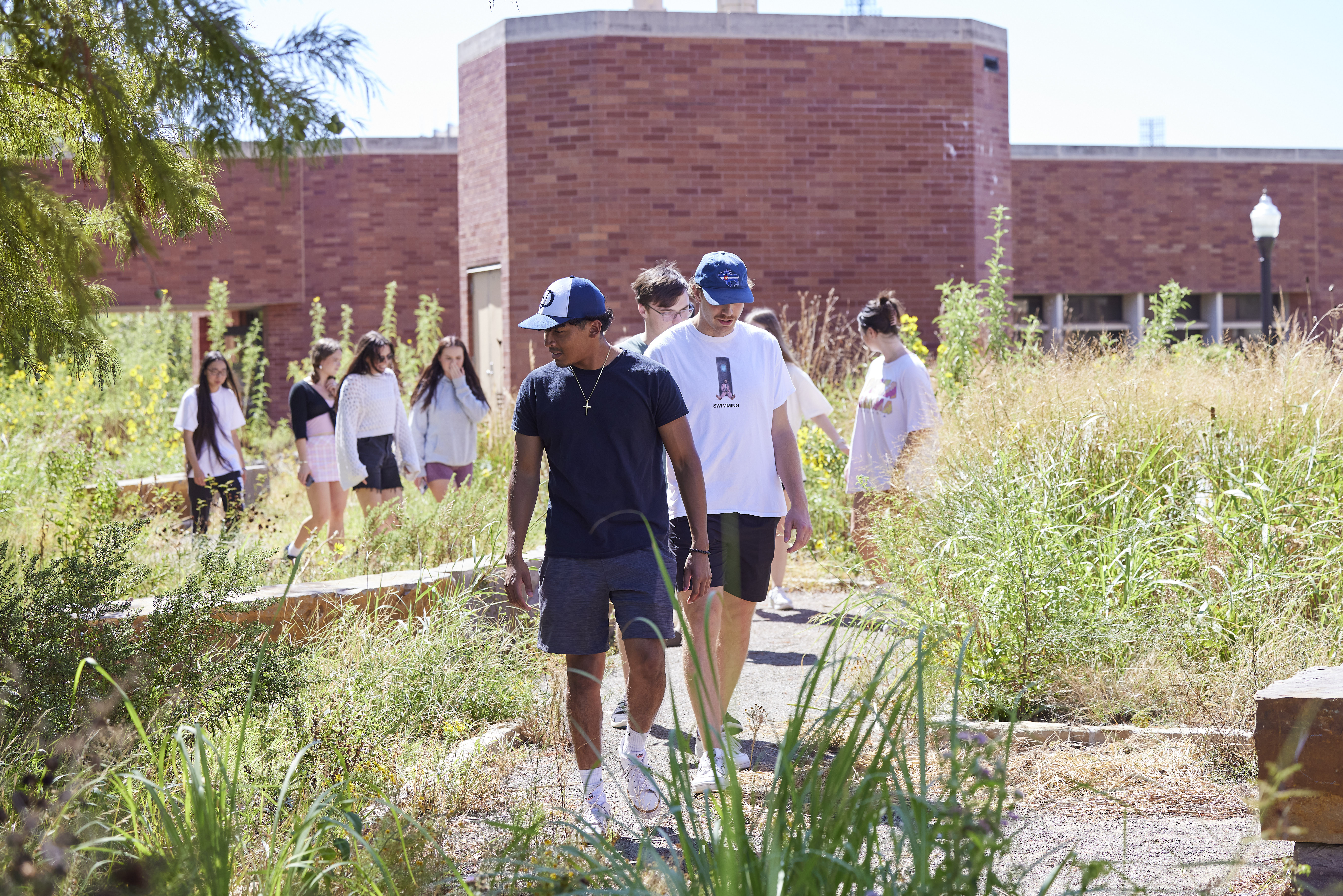 Students walking in the butterfly garden.