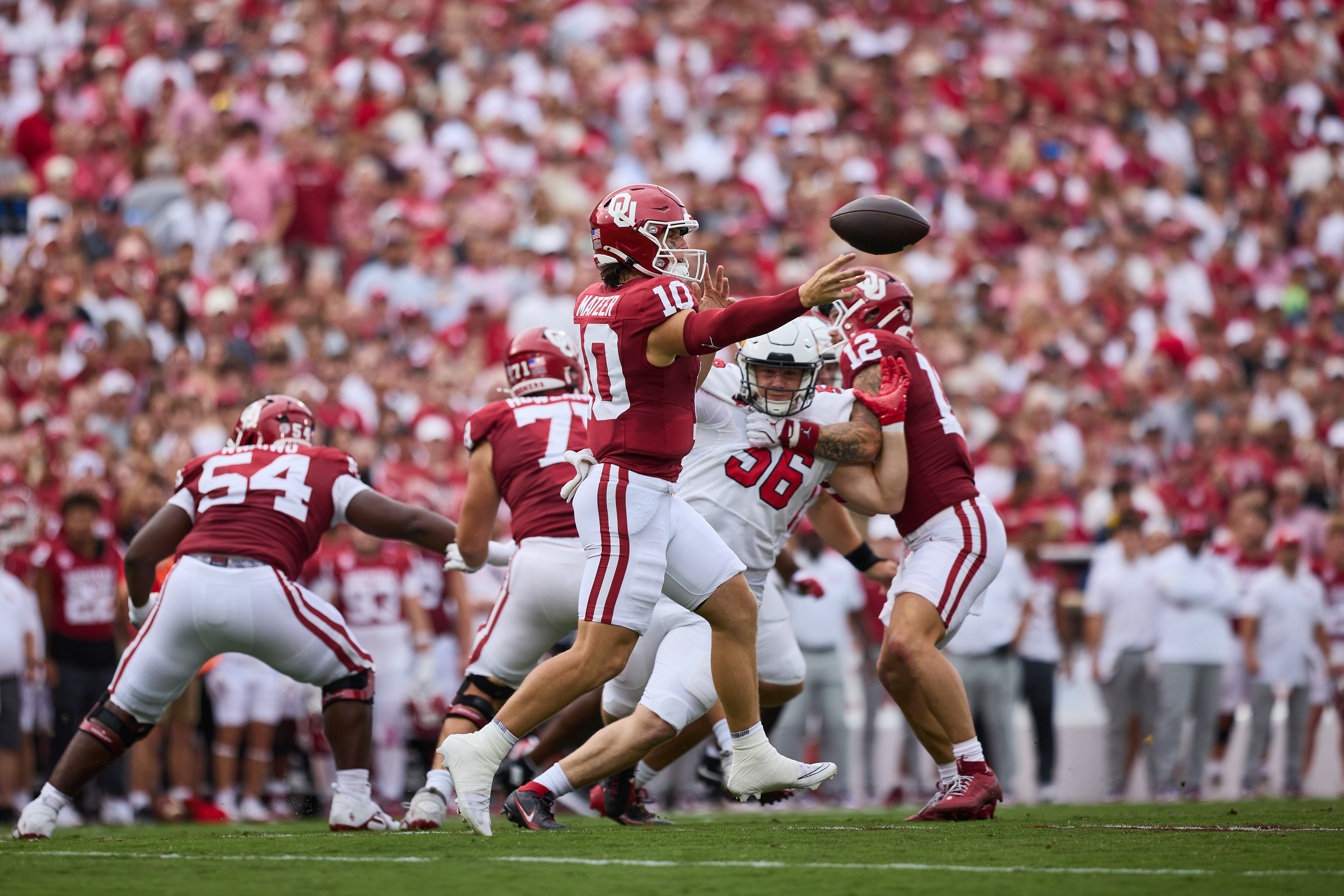 Quarterback, John Mateer, throws the football during a play