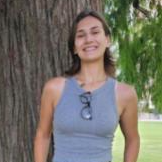 Jasmine standing in front of a tree