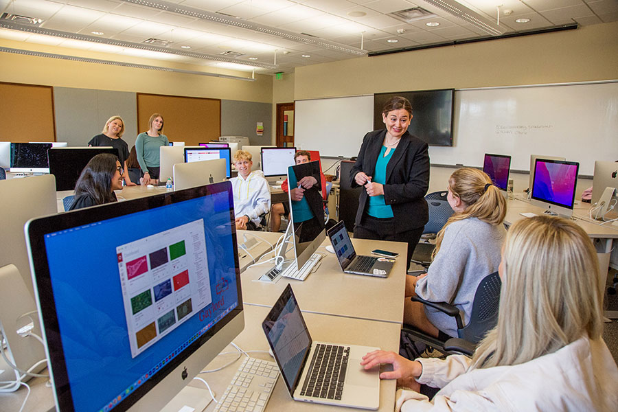 a professor is talking to students in a classroom