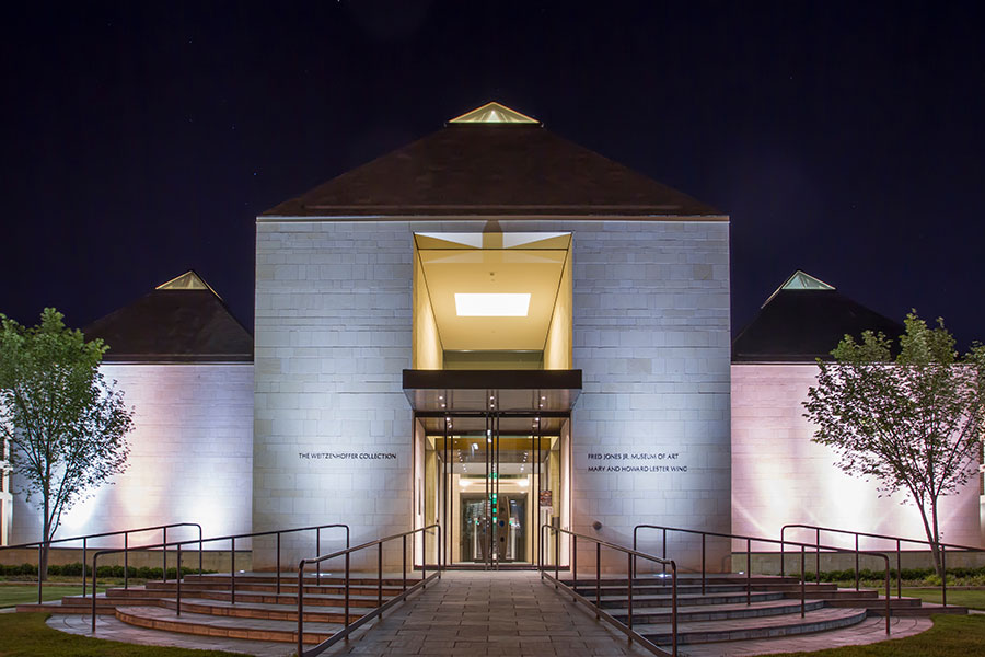Exterior of Fred Jones Jr. Museum of Art at night.