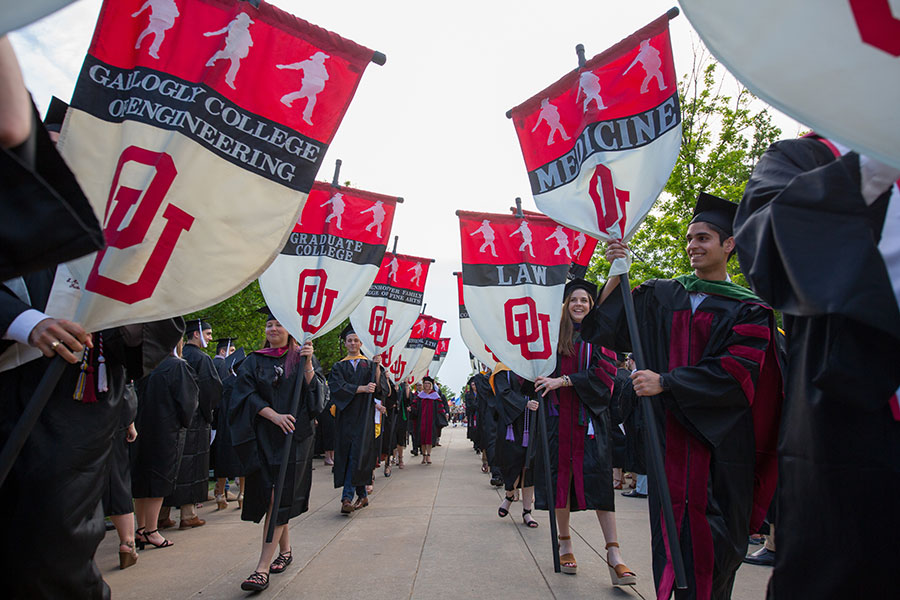 OU flags carried by students in graduation parade