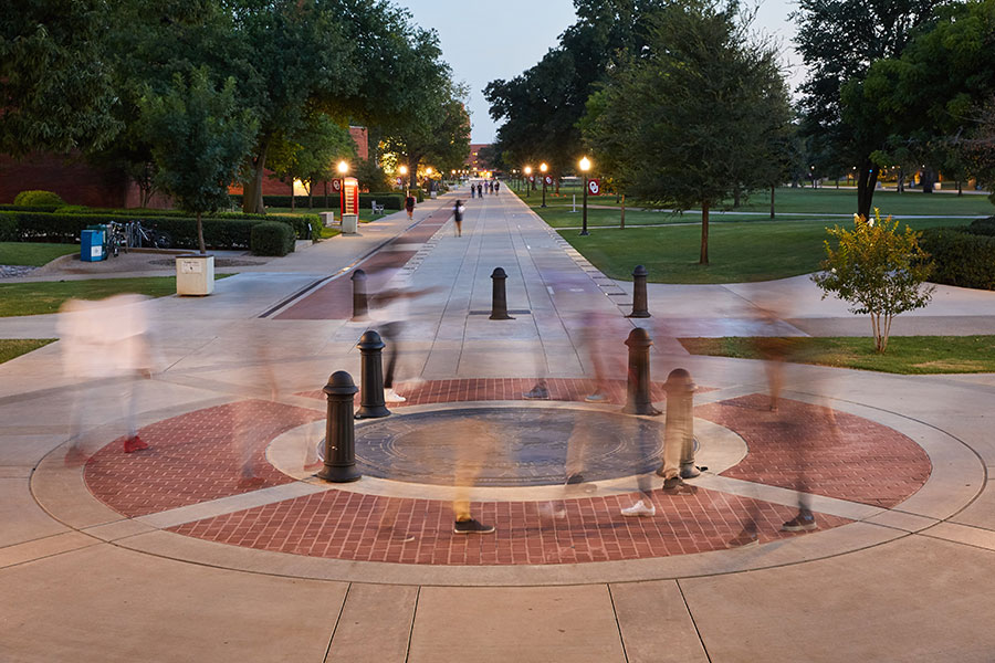 Scholar's Walk on the University of Oklahoma Norman campus at dusk.