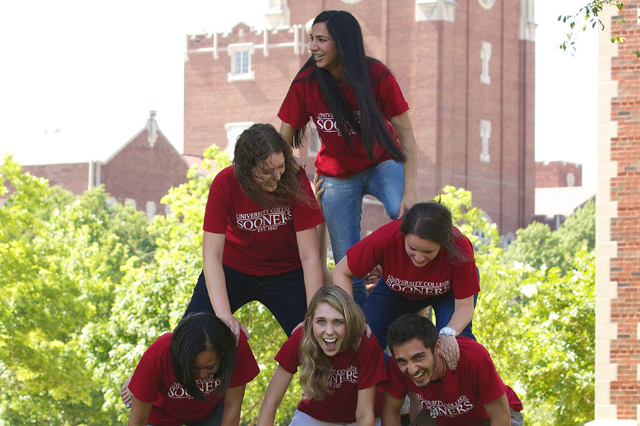 O U students forming a human pyramid.
