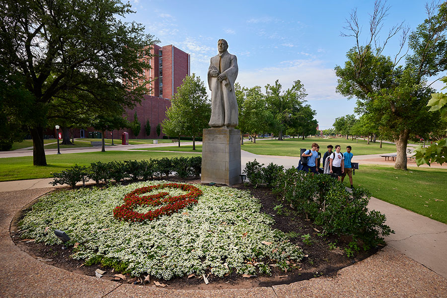 Statue surrounded by a flower garden