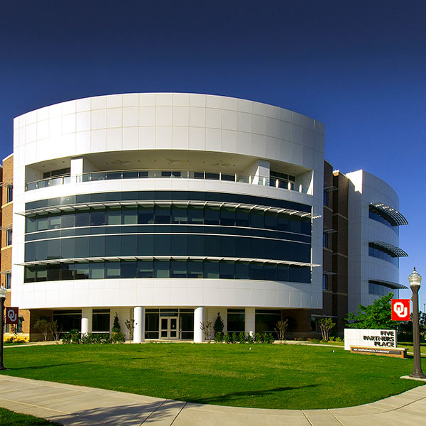 The exterior of 5 Partners Place, with a blue sky in the background.