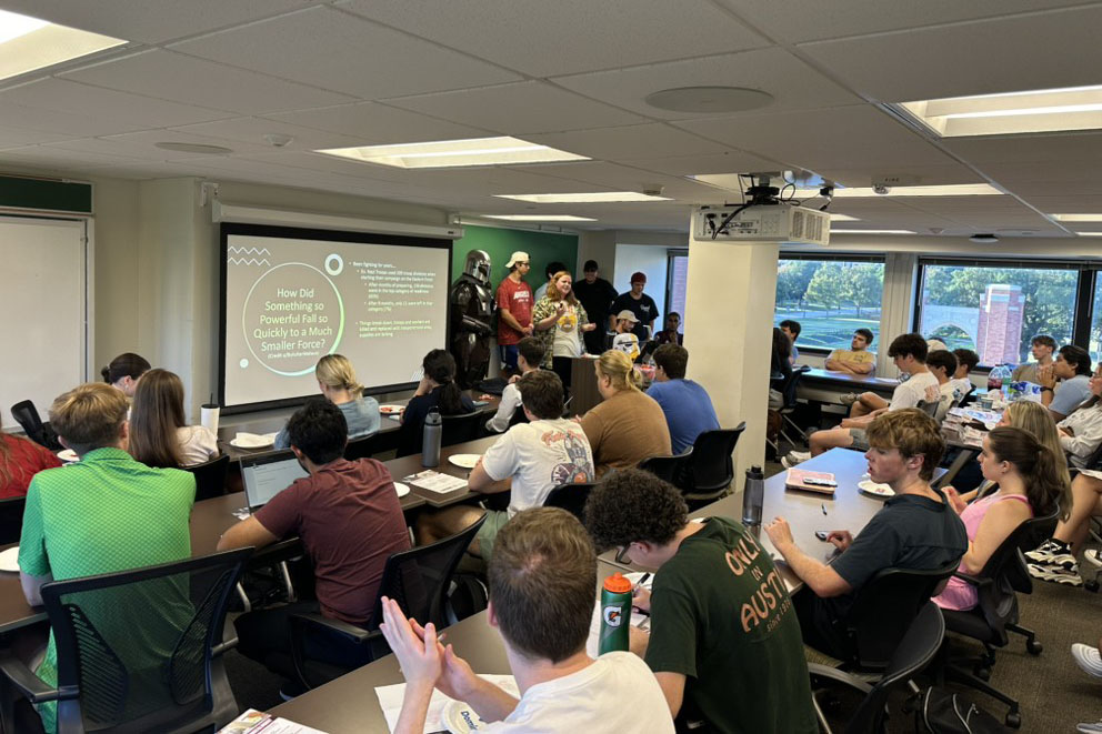 Dr. Johnson speaking about Star Wars next to Mando. 