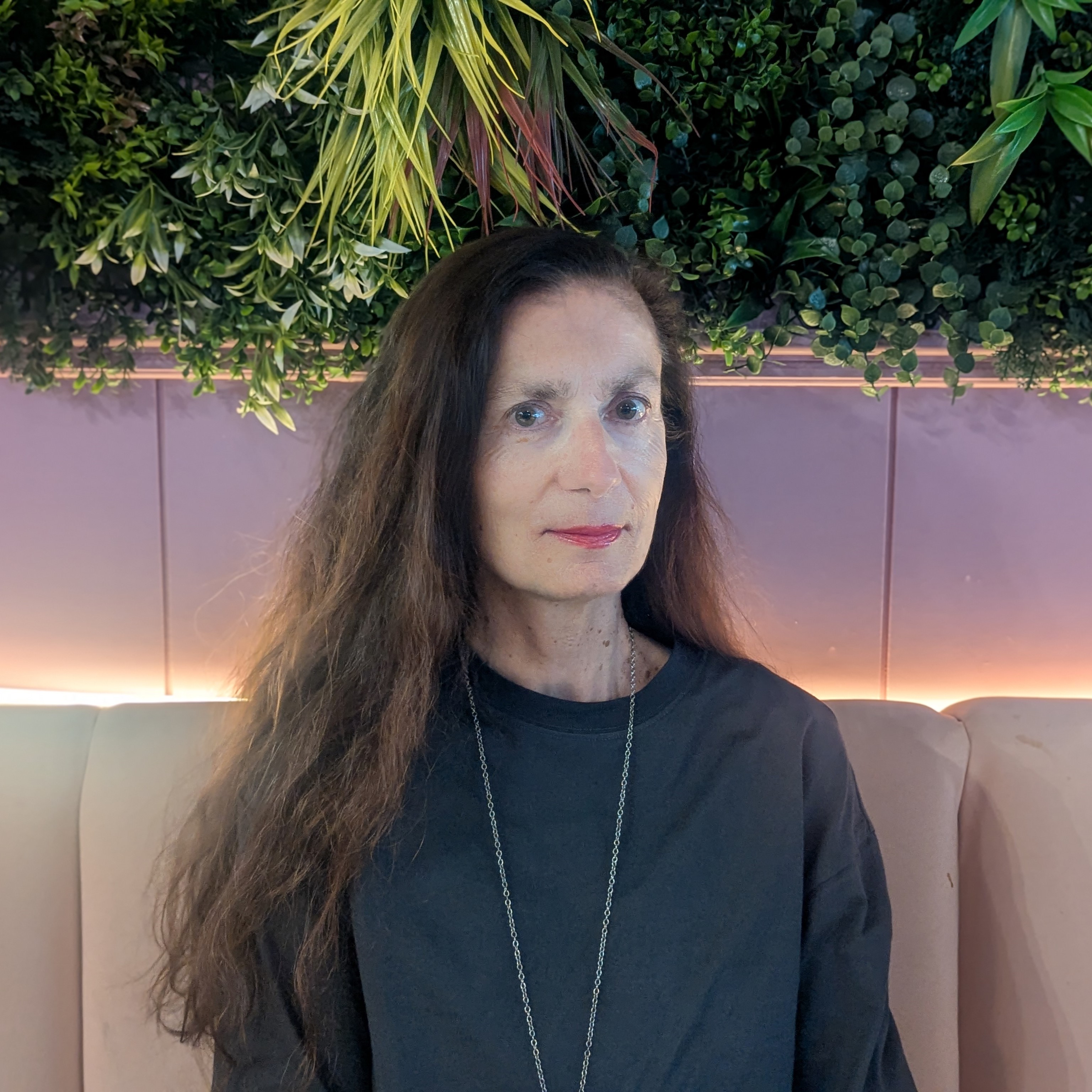 A person silhouette icon in white over a crimson background.