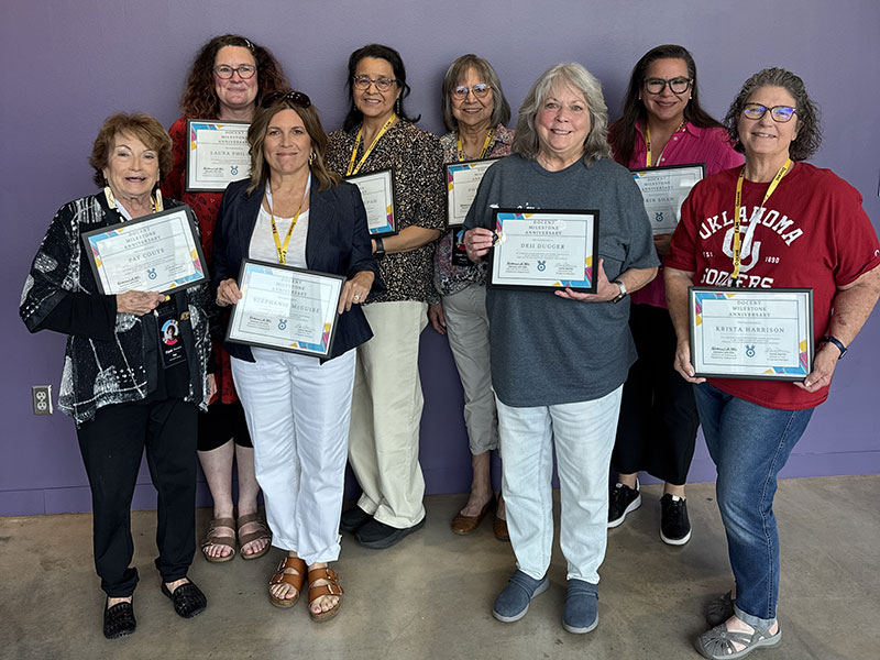 Phillips recognized with other docents for one year of service.
