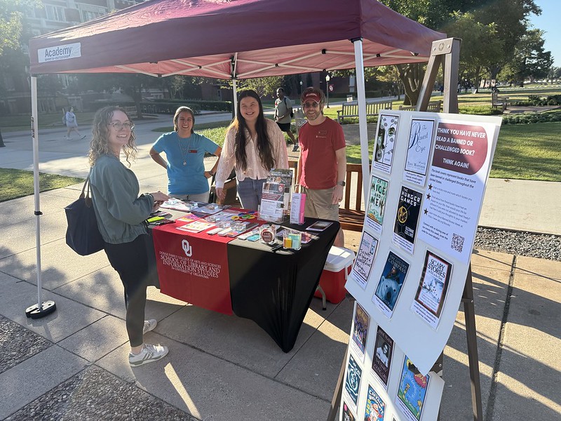 People gather at the Banned Books Week information booth outside on the south oval.