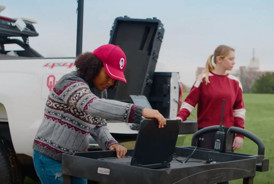 Two OU students in the field with equipment.