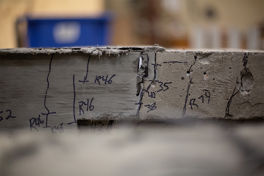 Concrete beam undergoing stress testing.