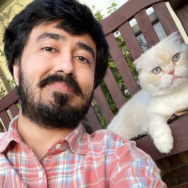 Tashfeen Ahmad and his white cat.