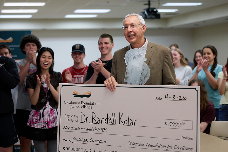 Dr. Randall Kolar and a group of students with his check and award.