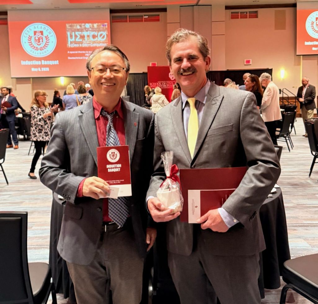 Dr. Yang Hong (left) with Dr. Jonathan "JJ" Gourley (right) at the induction ceremony.